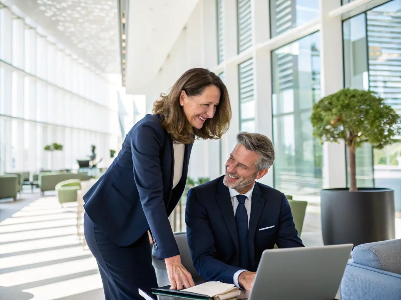 A close-up shot of Leona, the founder, smiling warmly and engaging in a collaborative discussion with a client in a modern office setting. The image should convey trust, approachability, and a personalized service experience.